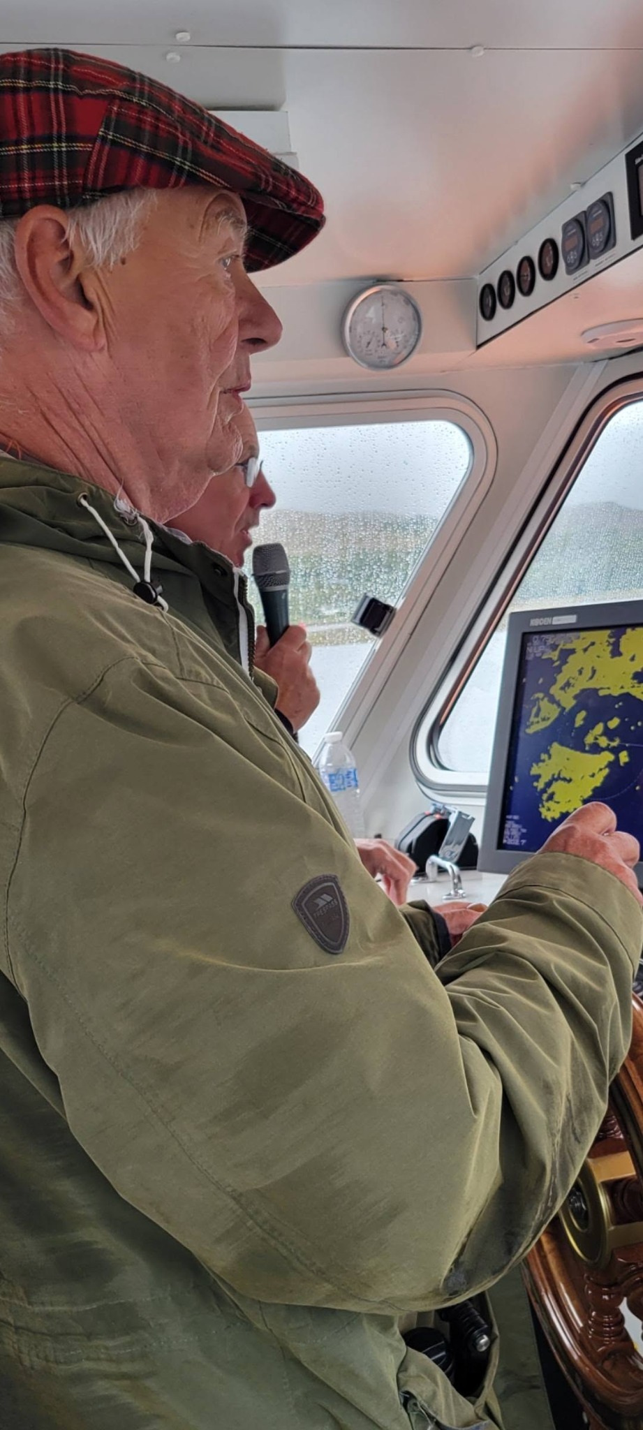 Dave steering the Loch Linnhe tour boat inside the wheelhouse