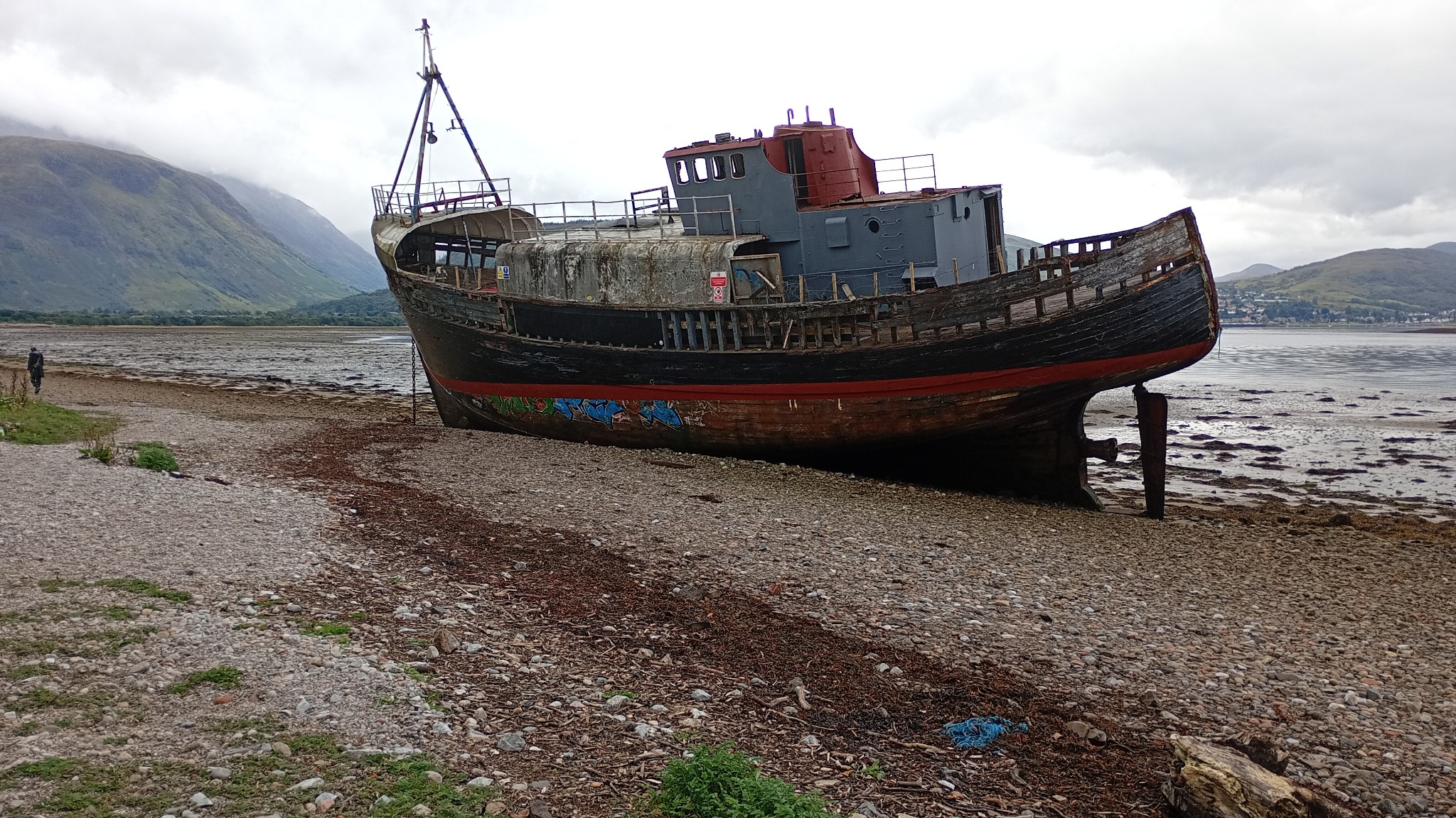 A shipwreck on Loch Linnhe with a fisherman in the water